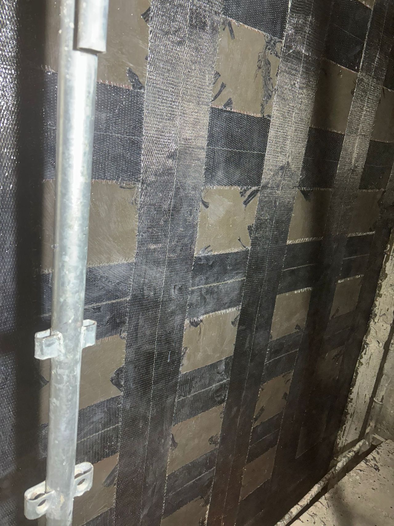 Carbon fibre fabric applied to a wall for seismic strengthening